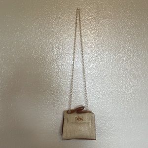 - Small tan and brown basket style cross body bag.